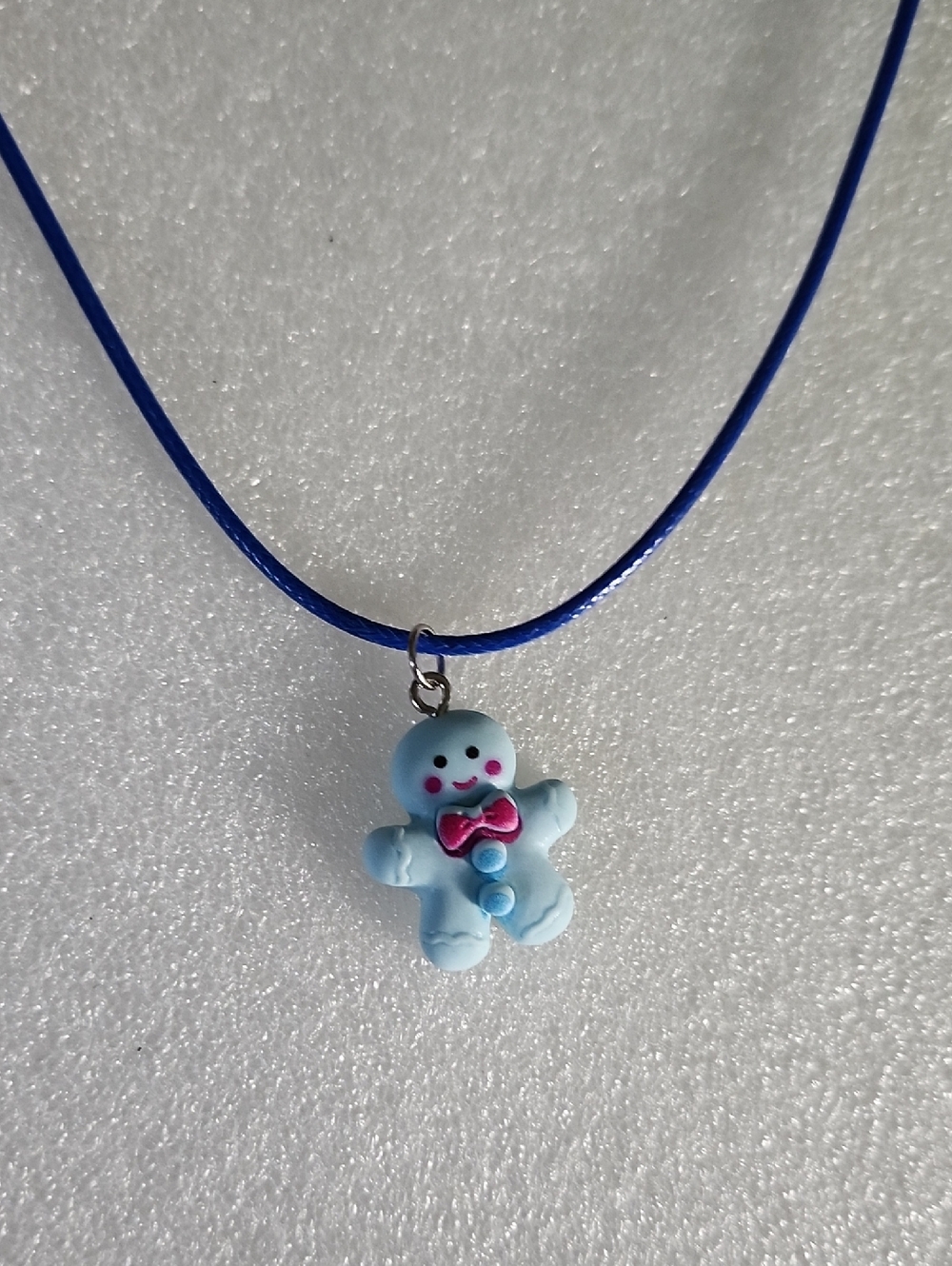 Hand Crafted Blue Gingerbread Man Necklace with Pink Bow